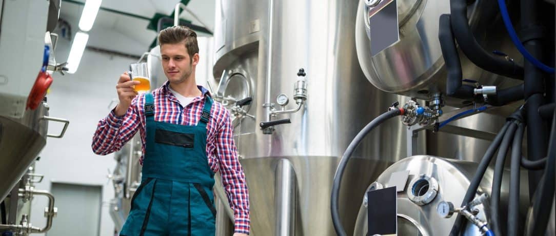 Worker Holding Beer In A Brewery